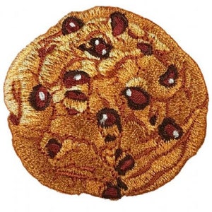 May include: A brown embroidered patch shaped like a chocolate chip cookie with brown and red chocolate chips.