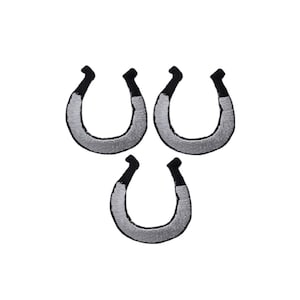 May include: Three embroidered horseshoe patches arranged in a triangular formation. Each patch features a silver-grey metallic thread body with black thread detailing at the tips, creating a distinct U-shaped design with a textured stitched finish.