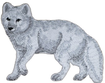 May include: An embroidered patch depicting an arctic fox standing on all fours. The fox is facing the left side of the image. The patch is suitable for sewing or ironing onto clothing, bags, or other fabric items.