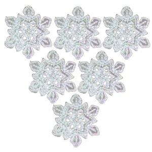 May include: Six white iridescent snowflake-shaped embellishments with a delicate, lacy design.