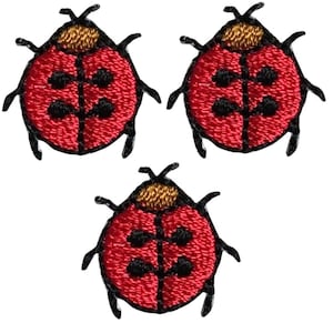 May include: Three red ladybug embroidered iron-on patches with black spots and gold accents.
