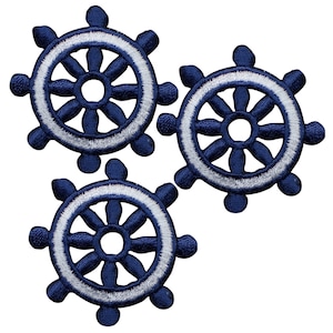 May include: Three blue and white nautical wheel embroidery patches. Each patch has a white outline and a blue centre with spokes.