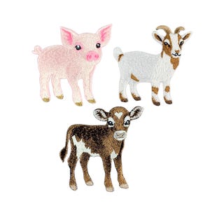 以下が含まれることがあります： 農場の動物をモチーフにした3つの刺繍ワッペン。淡いピンクの子豚、角が曲がった白と茶色のヤギ、額にハート型の模様がある濃い茶色と白の子牛が、それぞれ立っている姿でデザインされています。