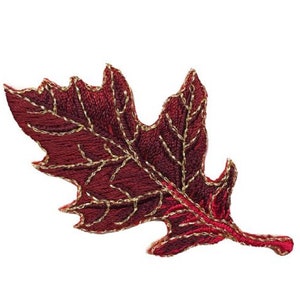 May include: A burgundy embroidered leaf with gold-colored stitching. The leaf has a detailed texture and a defined shape, with the gold stitching outlining the veins and edges. The leaf is likely a decorative element.