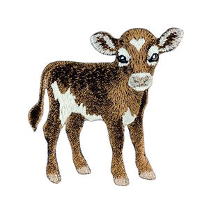 May include: An embroidered patch featuring a brown and white calf standing in profile. The calf has dark brown fur, white patches on its flank and chest, a white heart-shaped marking on its forehead, and light-coloured hooves on all four legs.