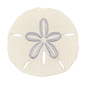 May include: A circular, off-white fabric patch featuring an embroidered, five-petaled star design in a light gray thread. The patch has a textured, woven appearance with five small, elongated cutouts positioned around the central star motif.