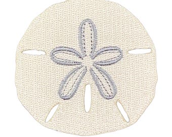 May include: A circular, off-white fabric patch featuring an embroidered, five-petaled star design in a light gray thread. The patch has a textured, woven appearance with five small, elongated cutouts positioned around the central star motif.