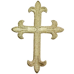 May include: Gold embroidered cross with a fleur-de-lis design. The cross is a religious symbol and is often used in Christian art and decoration.
