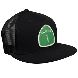 May include: Black trucker hat with a green and white California Highway 1 patch.