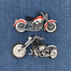 May include: Two embroidered motorcycle patches. The top patch depicts a cruiser motorcycle in red, white, and black thread. The bottom patch features a chopper-style motorcycle rendered in black, white, and gray thread with a long front fork.