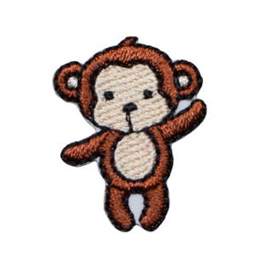 May include: Embroidered patch of a cartoon monkey in shades of brown, tan, and black. The monkey is waving with one arm raised. The patch has a white background and a black border.