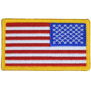 May include: A small embroidered American flag patch with a yellow border. The flag is red, white, and blue.