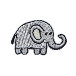 May include: A grey embroidered elephant patch with a black outline. The elephant has a curved trunk, small eyes, and a light beige ear. The patch is designed to be sewn or ironed onto fabric, suitable for clothing or accessories.