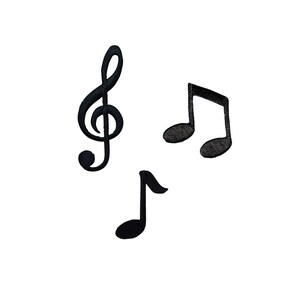May include: Three black embroidered patches featuring musical symbols. The set includes a treble clef, a beamed eighth note, and a single eighth note. Each patch has a textured, stitched surface with clearly defined edges and a solid black color.