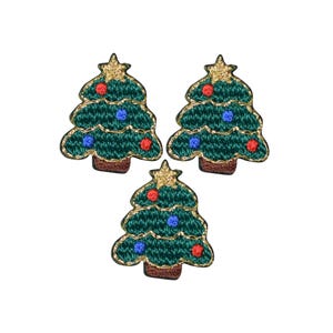 May include: Three embroidered patches shaped like Christmas trees. Each tree is dark green with gold metallic thread outlines, a gold star at the top, and small red and blue circular ornaments. Each tree has a brown rectangular base.