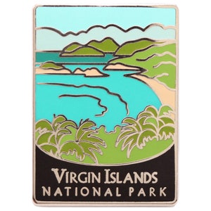May include: A silver enamel pin featuring a colourful illustration of a beach scene with palm trees, a bay, and mountains. The text "VIRGIN ISLANDS NATIONAL PARK" is printed in silver on a black background.