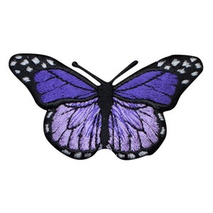 May include: Purple embroidered butterfly patch with black outlines and white accents.