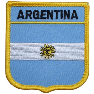May include: A blue and white embroidered patch with a yellow sun and the word "ARGENTINA" in black lettering. The patch has a yellow border.