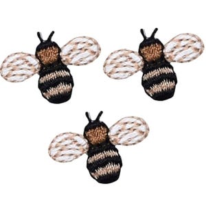 May include: Three embroidered bee patches with black and brown stripes, white wings, and brown heads.