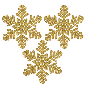 May include: Three gold glitter snowflakes with intricate details are arranged against a white background. Each snowflake has six points with detailed cutouts, creating a festive and decorative appearance. Ideal for holiday crafts.