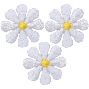 May include: Three white felt daisy flower patches with yellow centres.