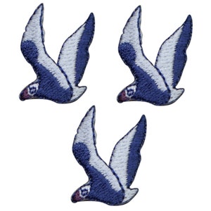 May include: Three blue and white embroidered bird patches. The birds are flying with their wings spread out.