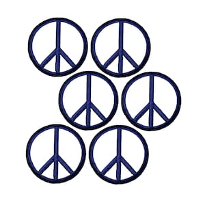 May include: A set of five circular embroidered patches, each featuring a dark blue peace sign symbol. The design consists of a dark blue circular border with a matching dark blue vertical line and two diagonal lines forming the peace emblem.