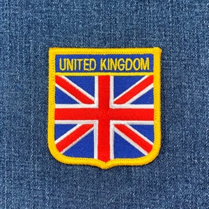 May include: A yellow and blue embroidered patch with the text "UNITED KINGDOM" and a red, white, and blue Union Jack flag design.