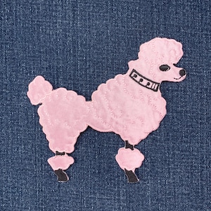 May include: Pink poodle patch with black accents, including a collar and paws. The patch is stitched onto a blue denim background. The poodle's fur is textured, and the design is a retro style.