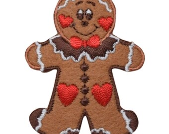 May include: A brown gingerbread man patch with a smiling face, red heart cheeks, and a red bow tie. The patch has white icing details and is a festive holiday decoration.