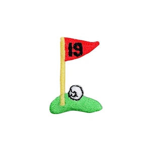 May include: An embroidered patch featuring a golf theme with a green patch of grass, a yellow flag pole, and a red triangular flag with the black number 19 stitched on it. A small white golf ball with black detailing sits on the green grass.