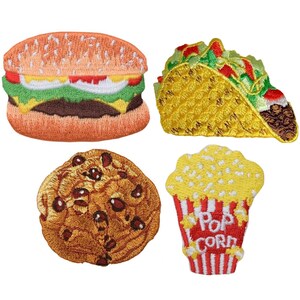 May include: Embroidered patches featuring a hamburger, taco, chocolate chip cookie, and popcorn. The hamburger has a sesame seed bun, lettuce, tomato, and a beef patty. The taco is filled with meat, lettuce, and tomato. The popcorn is in a red and white striped container.