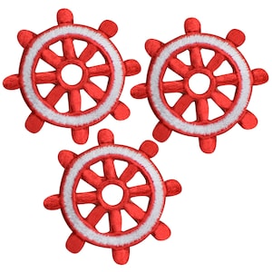 May include: Three red and white embroidered ship wheel patches. Each patch has a white outline and a red center with eight spokes.