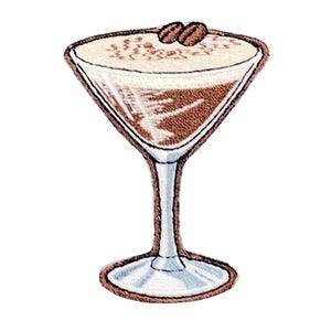 May include: An embroidered patch depicting a martini glass filled with a dark brown coffee-based cocktail. The drink is topped with a thick layer of white foam and two dark brown coffee beans. The glass has a clear stem and a wide base.