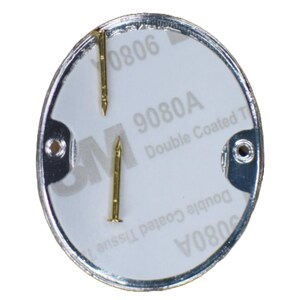 May include: A white oval sticker with the text "9080A Double Coated Tape" and the number "9080A" printed in black. The sticker is attached to a silver metal disc with two small gold tacks.