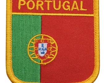 May include: A red, green and yellow embroidered patch with the word "PORTUGAL" in yellow lettering. The patch features the Portuguese coat of arms in the centre.