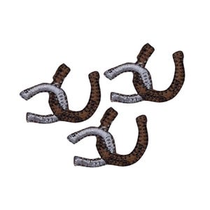 May include: Three embroidered patches, each shaped like a horseshoe. The patches feature a two-tone design with one side in a brown and black leopard print pattern and the other side in a metallic silver thread finish with a textured appearance.