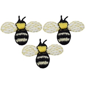 May include: Three embroidered bee patches. Each bee has a yellow head and a black and white striped body. The wings are a cream color. The bees are arranged in a triangular pattern.