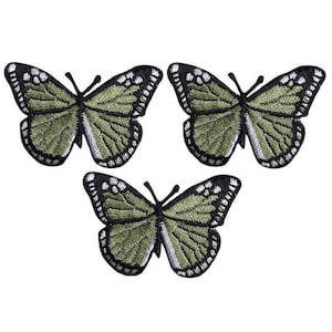 May include: Three green butterfly iron-on patches with black outlines. The butterflies have white accents on their wings.