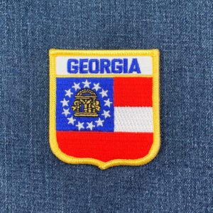 May include: A yellow, red, white, and blue embroidered patch with the word "GEORGIA" in blue letters and the state flag of Georgia.