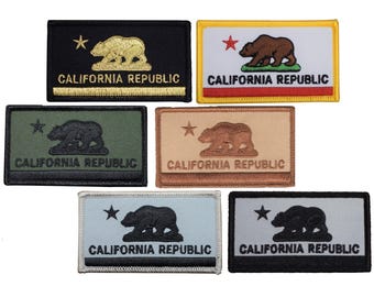May include: A selection of rectangular patches displaying the California state flag design. Each patch features a bear, a star, and the words "California Republic." The patches are in various colours, including black, green, tan, and blue.