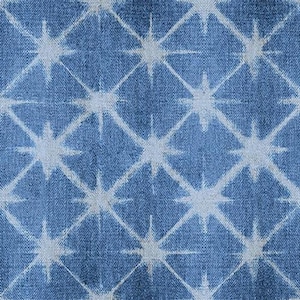May include: A blue denim fabric with a white geometric pattern. The pattern is made up of repeating stars.