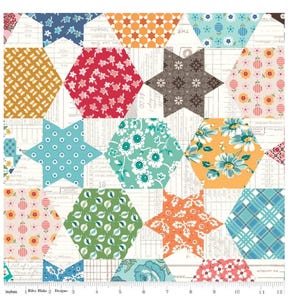 May include: A patchwork fabric featuring a repeating pattern of stars and hexagons in various colors and patterns, including blue, green, red, orange, yellow, and white. The fabric has a vintage, hand-stitched look.