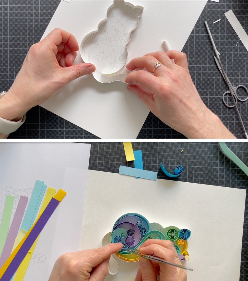 May include: A person is creating a paper craft of a cat using colorful paper strips. The cat is outlined in pencil on a white sheet of paper. The person is using tweezers to place the paper strips in the outline.
