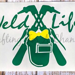 May include: Green and yellow "Weld Life" decal with a welding helmet and crossed welding torches. The decal also includes the text "Crafting for Change" and a colorful logo in the upper right corner.