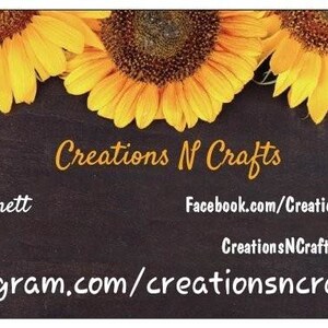 May include: A business card design featuring three bright yellow sunflowers at the top. The text "Creations N Crafts" is in a cursive font. Additional text includes the owner's name, and social media links.