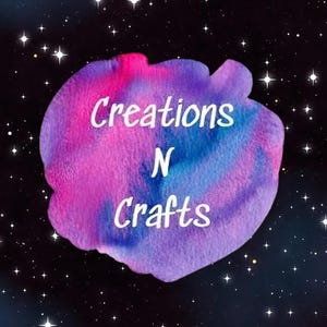 May include: A logo for "Creations N Crafts" against a starry background. The logo features a watercolor-style design with pink, blue, and purple hues. White text spells out the business name.