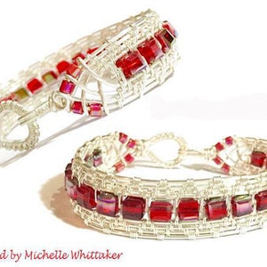 May include: Two silver wire wrapped bracelets with red iridescent glass beads. The bracelets are designed in a woven pattern.