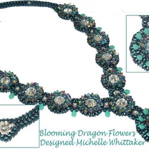 May include: A teal and silver beaded necklace with a large, round pendant. The necklace features a repeating pattern of flower-shaped beads. The pendant is made of teal and silver beads and has a teardrop shape. The necklace is labelled "Blooming Dragon Flowers Designed Michelle Whittaker".