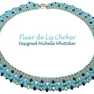 May include: A light blue beaded choker necklace with a silver clasp. The necklace is designed in a fleur-de-lis pattern and features a variety of blue and silver beads. The text "Fleur de Lis Choker Designed Michelle Whittaker" is printed on a white background.